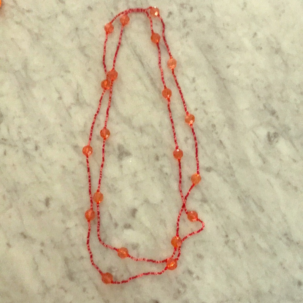 Long continuous beaded necklace.